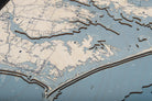 Outer Banks, North Carolina 3D layered wood map in laser-cut Baltic birch, shown framed against a light wall