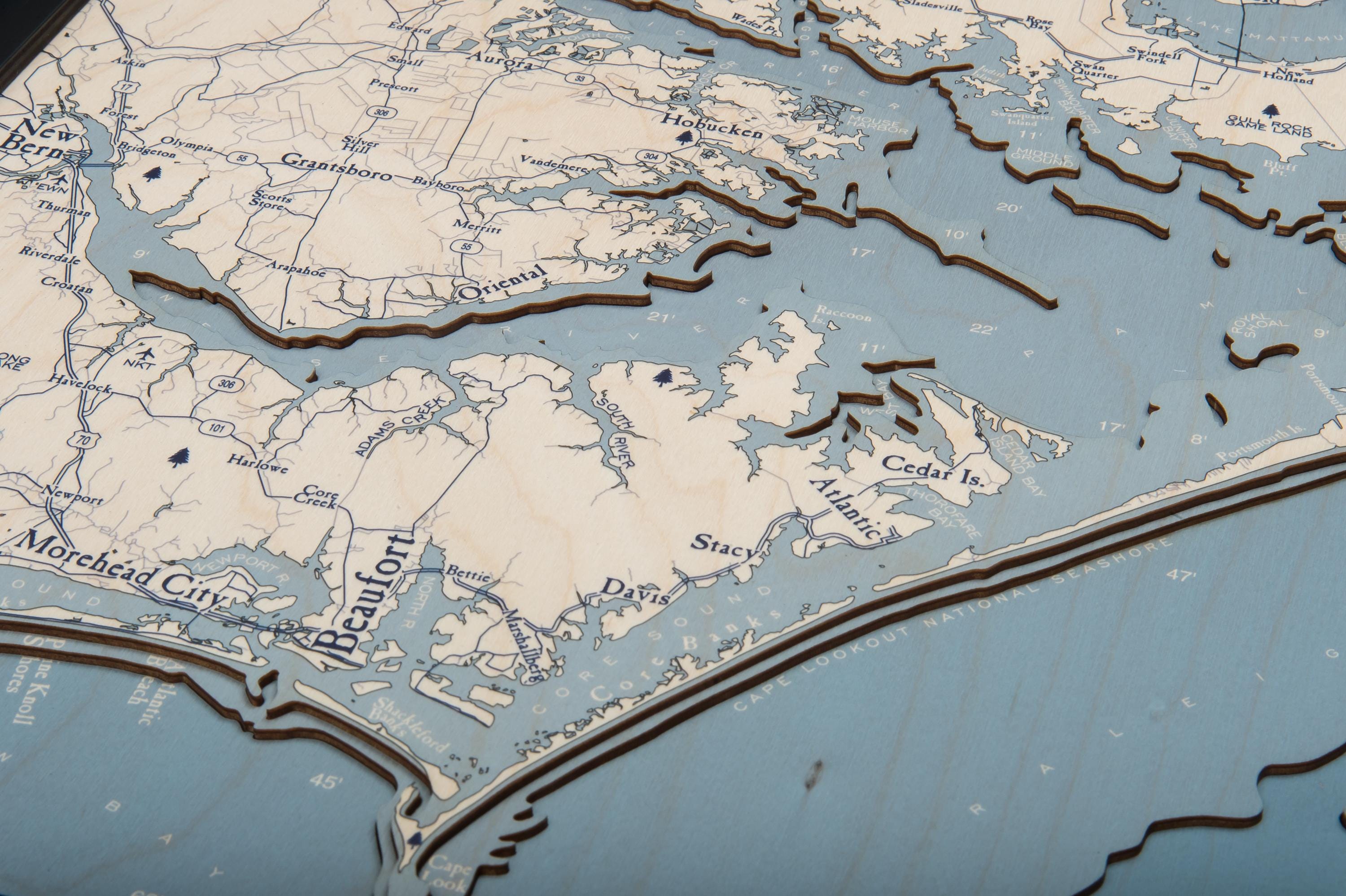Outer Banks, North Carolina 3D layered wood map in laser-cut Baltic birch, shown framed against a light wall
