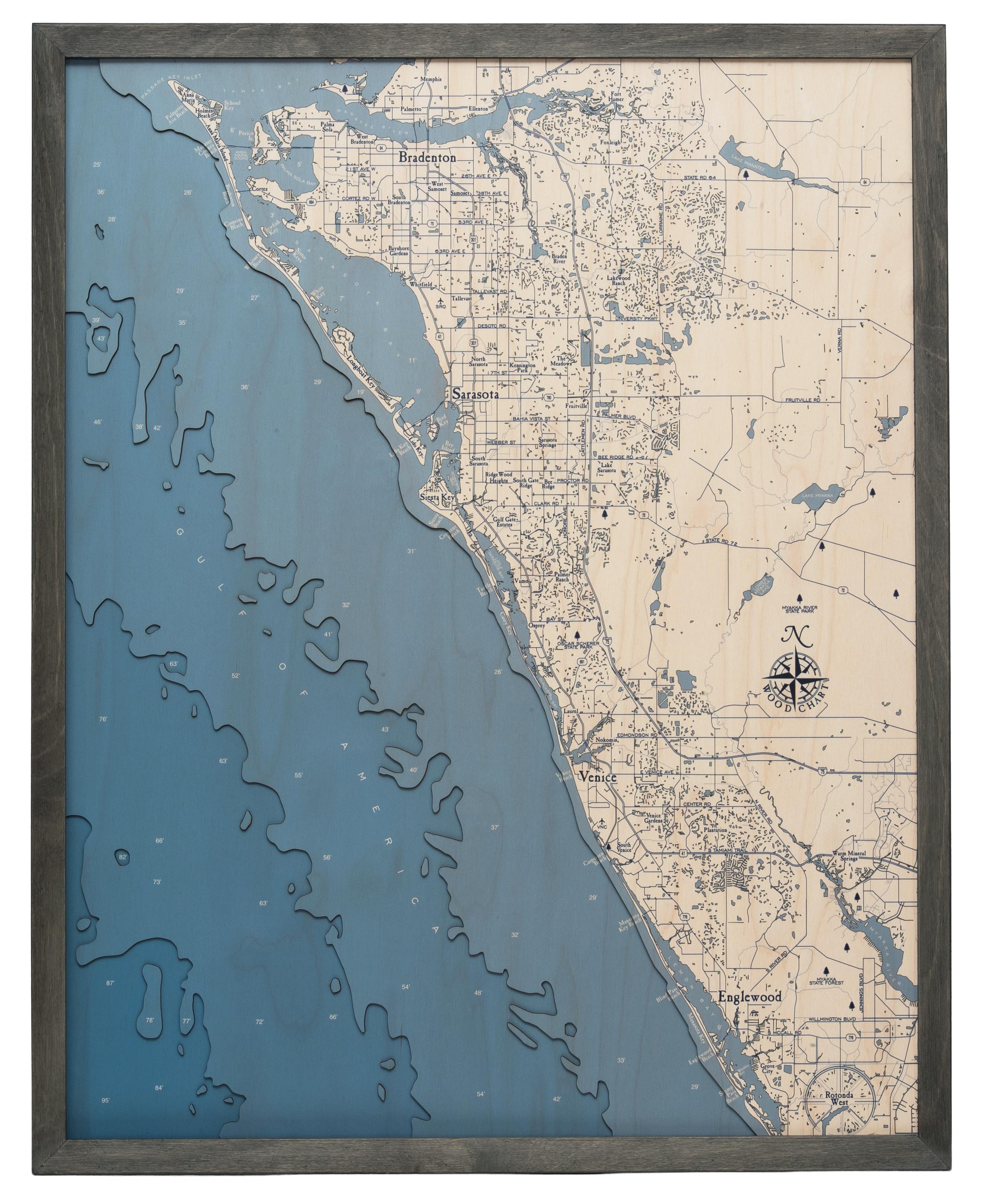 Sarasota to Venice, Florida 3D layered wood map in laser-cut Baltic birch, shown framed against a light wall
