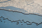 Sarasota to Venice, Florida 3D layered wood map in laser-cut Baltic birch, shown framed against a light wall
