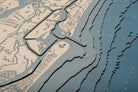 New Smyrna Beach, Florida 3D layered wood map in laser-cut Baltic birch, shown framed against a light wall