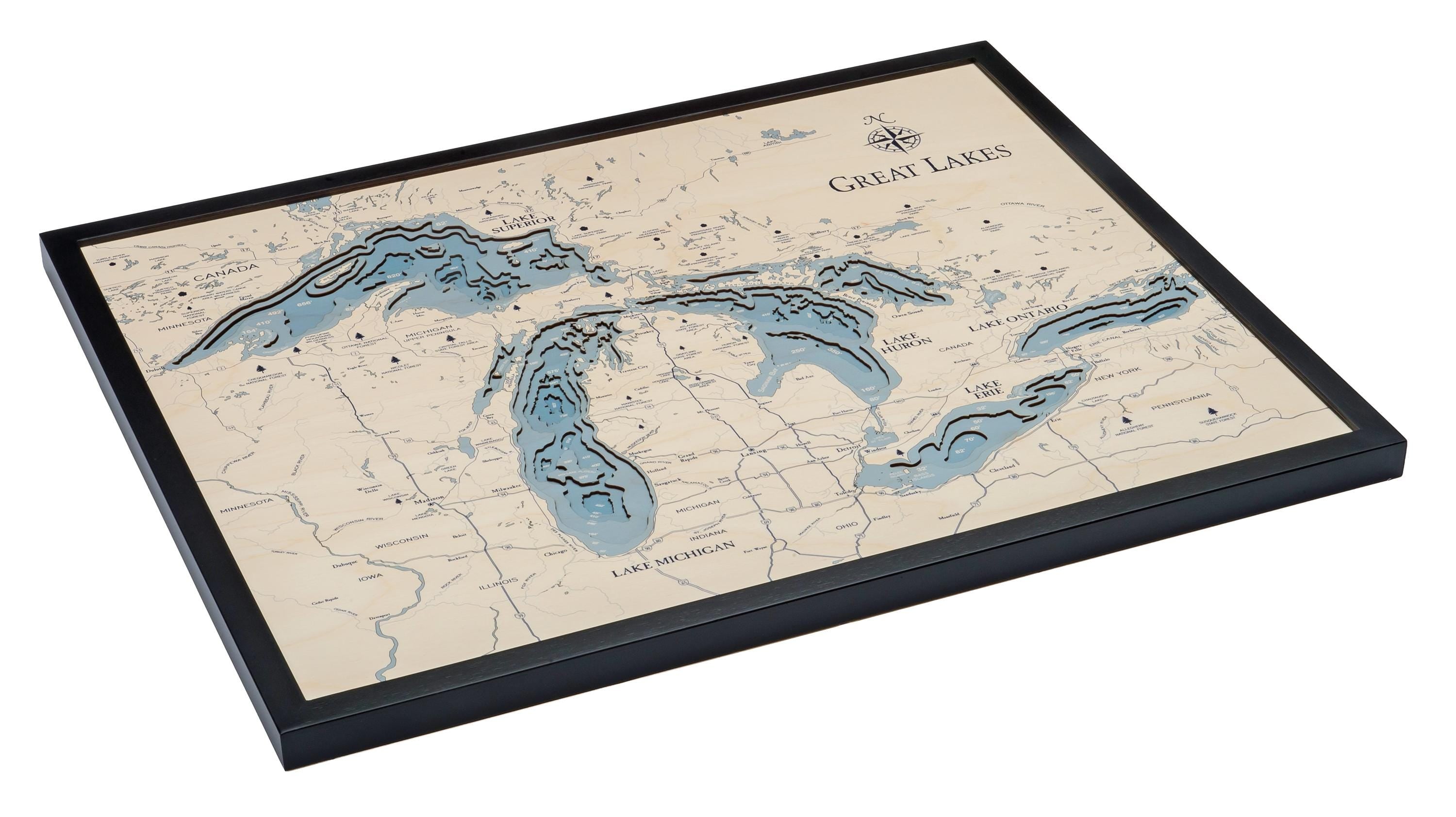 Great Lakes 3D layered wood map in laser-cut Baltic birch, shown framed against a light wall
