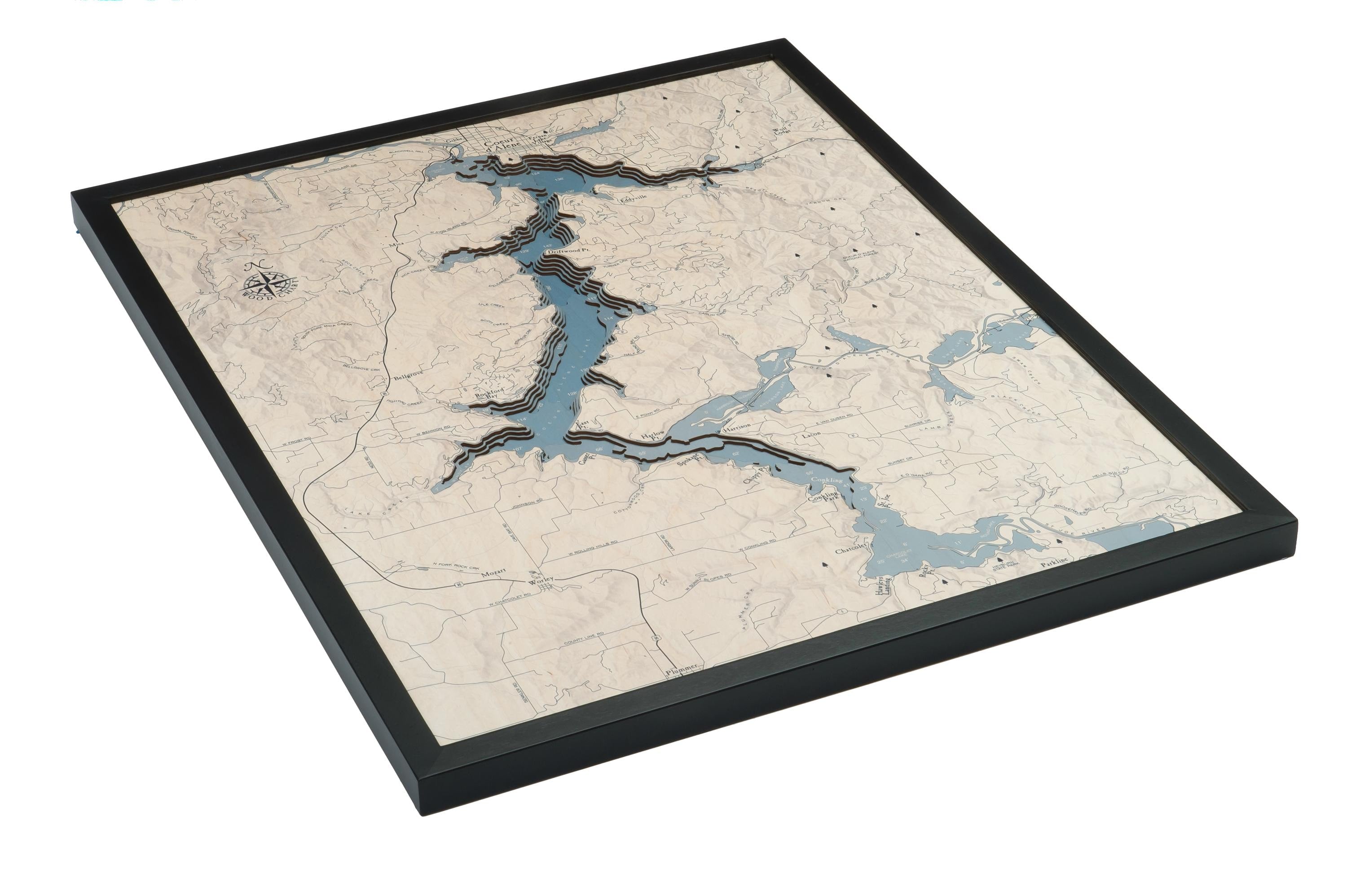 Lake Coeur d'Alene, Idaho 3D layered wood map in laser-cut Baltic birch, shown framed against a light wall