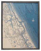 New Smyrna Beach, Florida 3D layered wood map in laser-cut Baltic birch, shown framed against a light wall