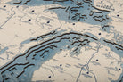 Great Lakes 3D layered wood map in laser-cut Baltic birch, shown framed against a light wall