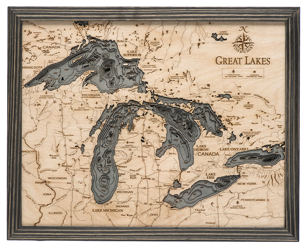 Great Lakes 3D layered wood map in laser-cut Baltic birch, shown framed against a light wall