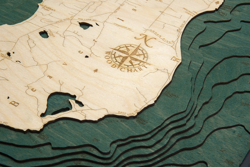 Beaver Island, Michigan 3D layered wood map in laser-cut Baltic birch, shown framed against a light wall
