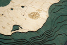 Beaver Island, Michigan 3D layered wood map in laser-cut Baltic birch, shown framed against a light wall