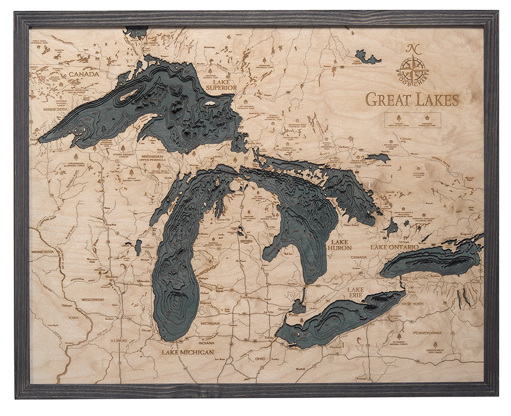 Great Lakes 3D layered wood map in laser-cut Baltic birch, shown framed against a light wall
