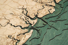 Georgia Coast 3D layered wood map in laser-cut Baltic birch, shown framed against a light wall