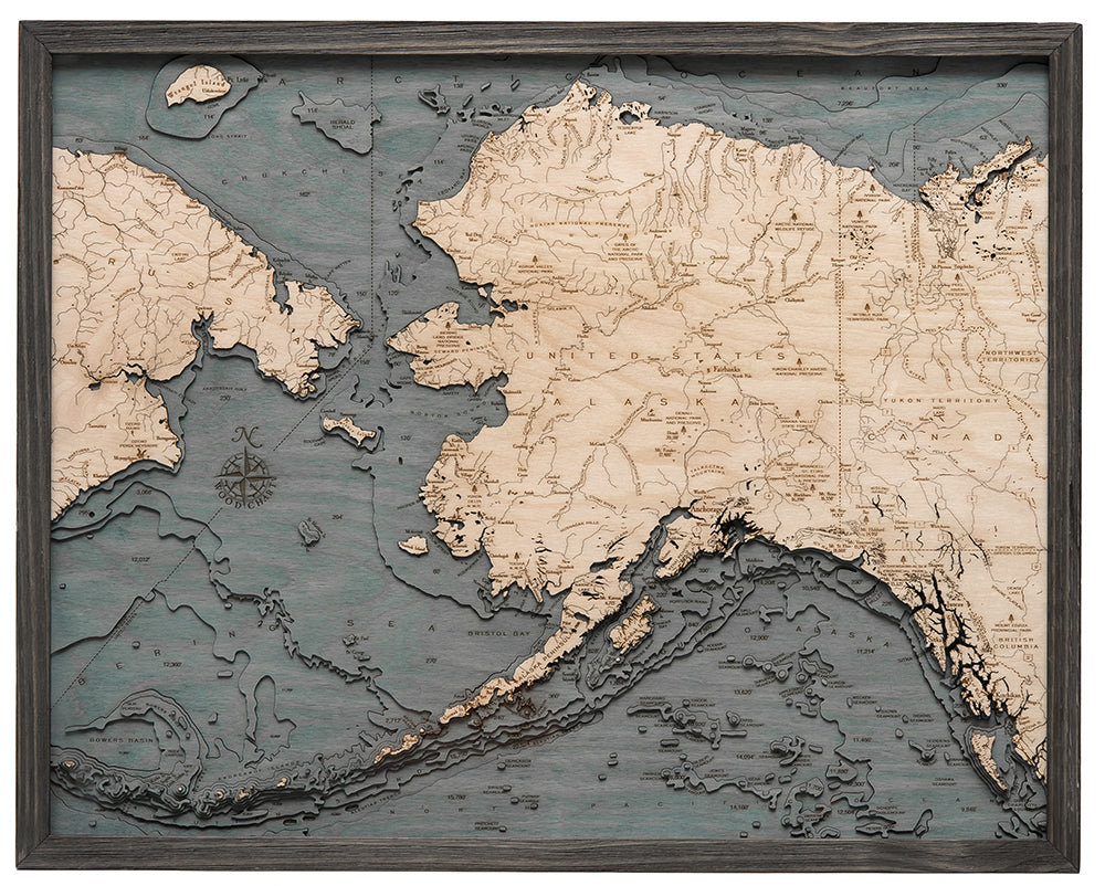 Alaska 3D layered wood map in laser-cut Baltic birch, shown framed against a light wall