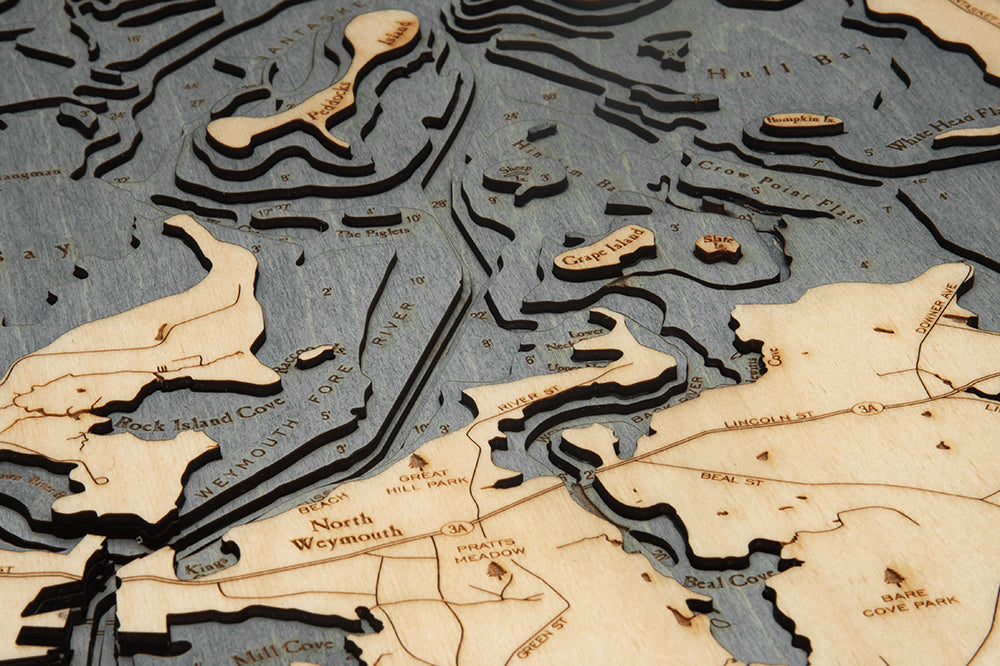 Boston Harbor, Massachusetts 3D layered wood map in laser-cut Baltic birch, shown framed against a light wall