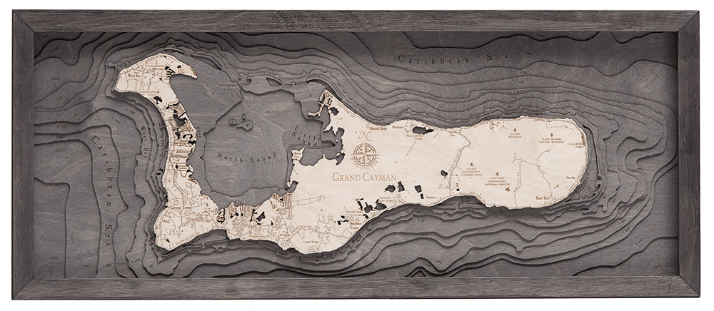Grand Cayman, Caribbean 3D layered wood map in laser-cut Baltic birch, shown framed against a light wall