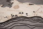 Grand Cayman, Caribbean 3D layered wood map in laser-cut Baltic birch, shown framed against a light wall