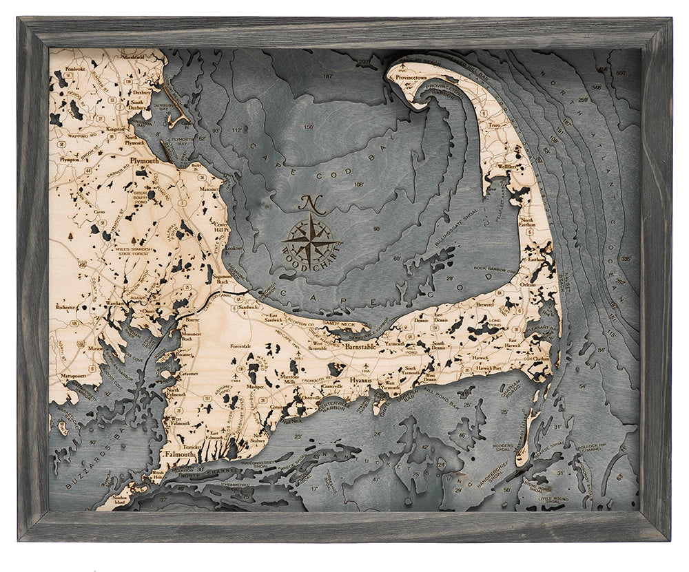 Cape Cod, Massachusetts 3D layered wood map in laser-cut Baltic birch, shown framed against a light wall