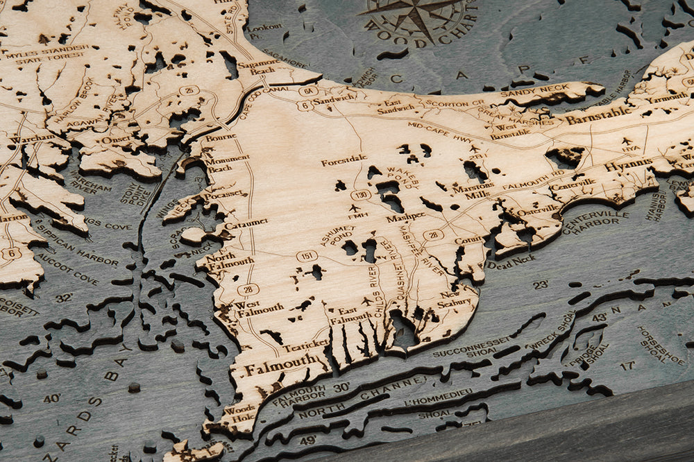 Cape Cod, Massachusetts 3D layered wood map in laser-cut Baltic birch, shown framed against a light wall