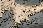 Cape Cod, Massachusetts 3D layered wood map in laser-cut Baltic birch, shown framed against a light wall