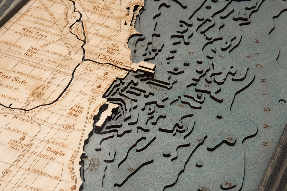Chicago, Illinois 3D layered wood map in laser-cut Baltic birch, shown framed against a light wall