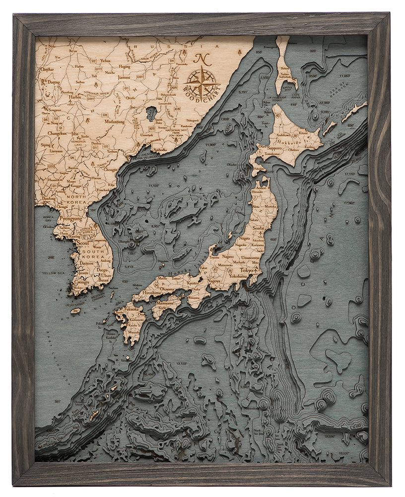 Japan 3D layered wood map in laser-cut Baltic birch, shown framed against a light wall