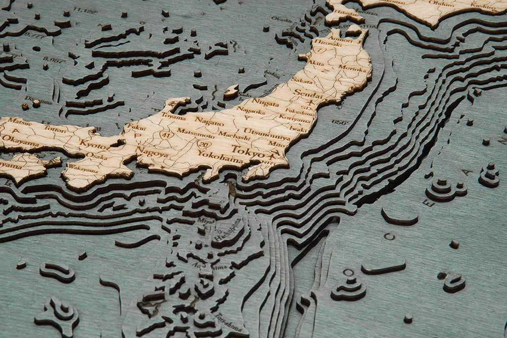 Japan 3D layered wood map in laser-cut Baltic birch, shown framed against a light wall