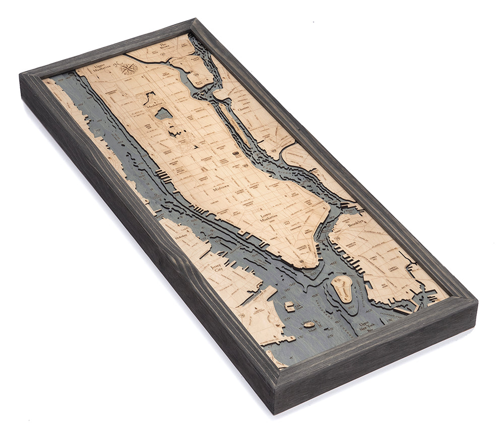 Manhattan, New York 3D layered wood map in laser-cut Baltic birch, shown framed against a light wall