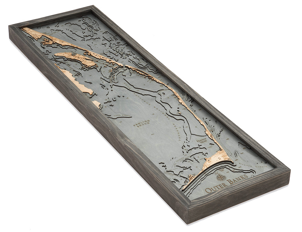 Outer Banks, North Carolina 3D layered wood map in laser-cut Baltic birch, shown framed against a light wall