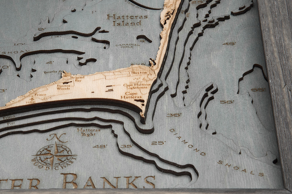 Outer Banks, North Carolina 3D layered wood map in laser-cut Baltic birch, shown framed against a light wall