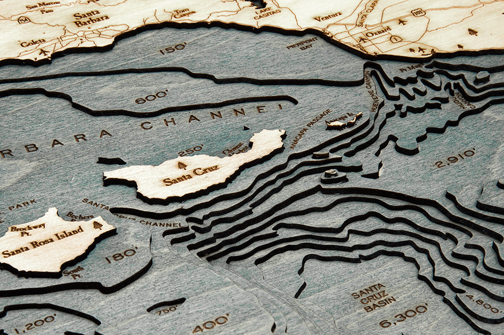Santa Barbara, California 3D layered wood map in laser-cut Baltic birch, shown framed against a light wall