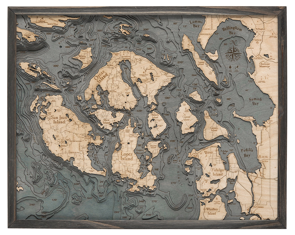 San Juan Islands, Washington 3D layered wood map in laser-cut Baltic birch, shown framed against a light wall