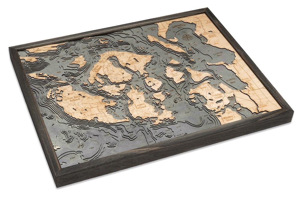 San Juan Islands, Washington 3D layered wood map in laser-cut Baltic birch, shown framed against a light wall