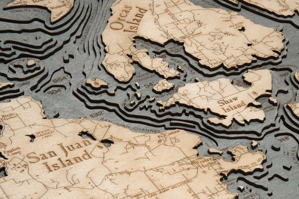 San Juan Islands, Washington 3D layered wood map in laser-cut Baltic birch, shown framed against a light wall