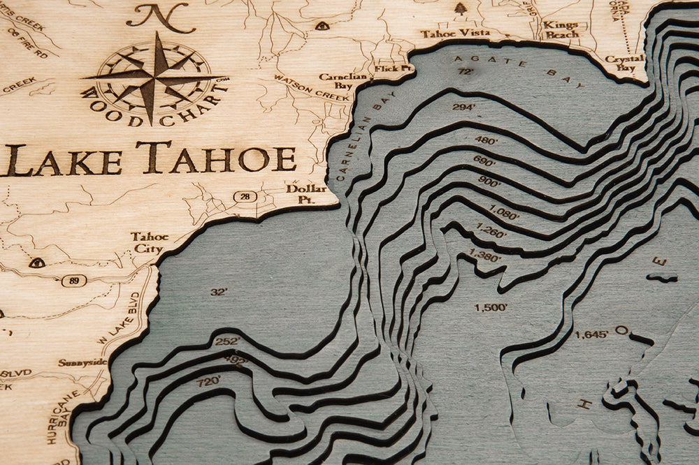 Lake Tahoe, California 3D layered wood map in laser-cut Baltic birch, shown framed against a light wall