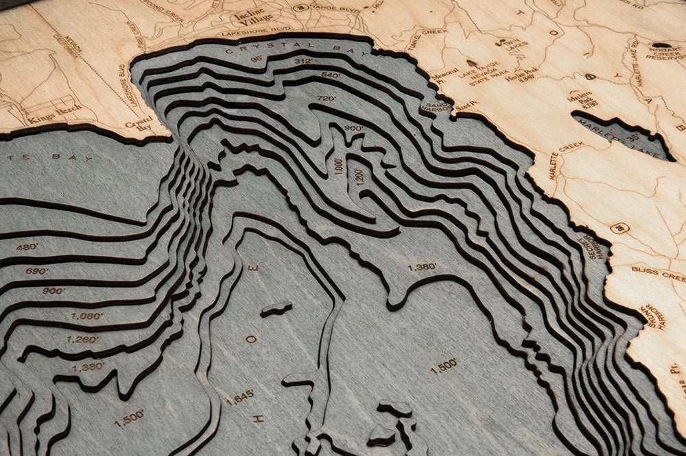 Lake Tahoe, California 3D layered wood map in laser-cut Baltic birch, shown framed against a light wall