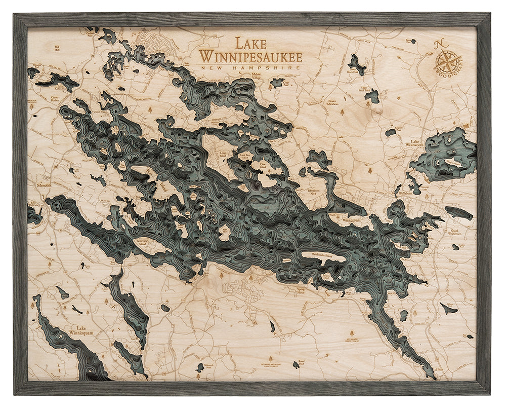 Lake Winnipesaukee, New Hampshire 3D layered wood map in laser-cut Baltic birch, shown framed against a light wall