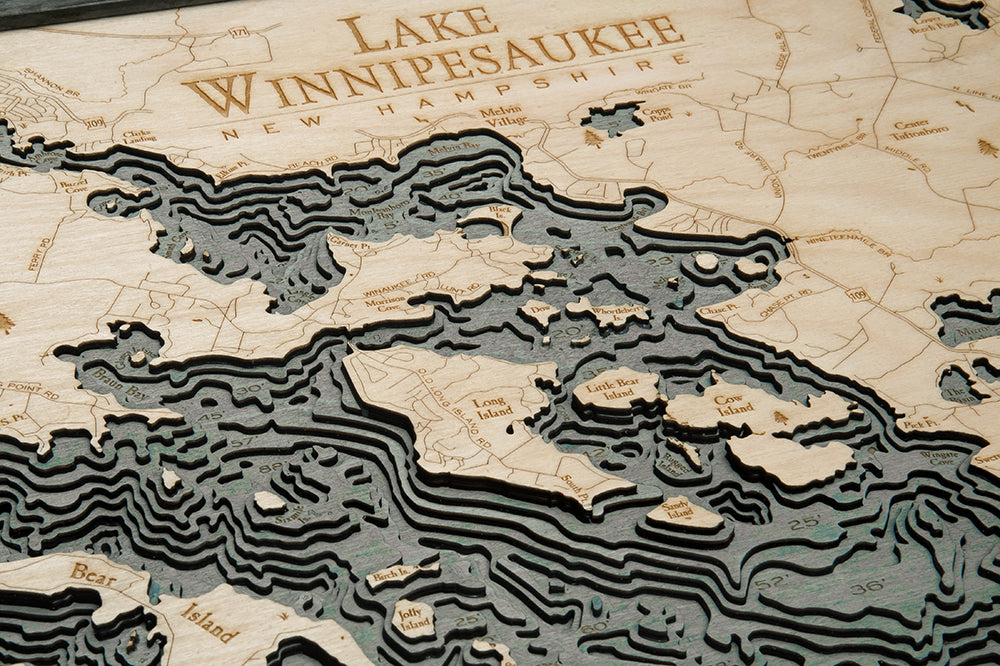 Lake Winnipesaukee, New Hampshire 3D layered wood map in laser-cut Baltic birch, shown framed against a light wall