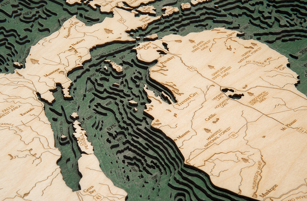 Great Lakes 3D layered wood map in laser-cut Baltic birch, shown framed against a light wall