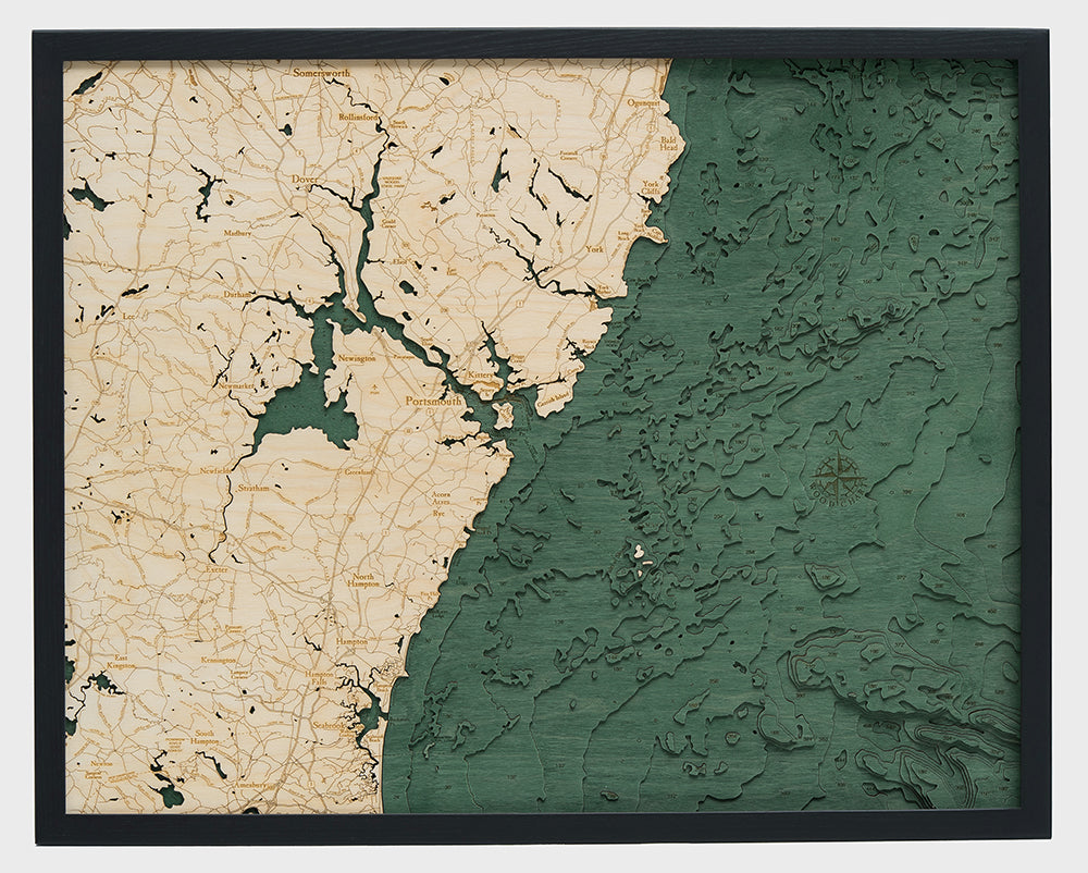 New Hampshire Coast 3D layered wood map in laser-cut Baltic birch, shown framed against a light wall
