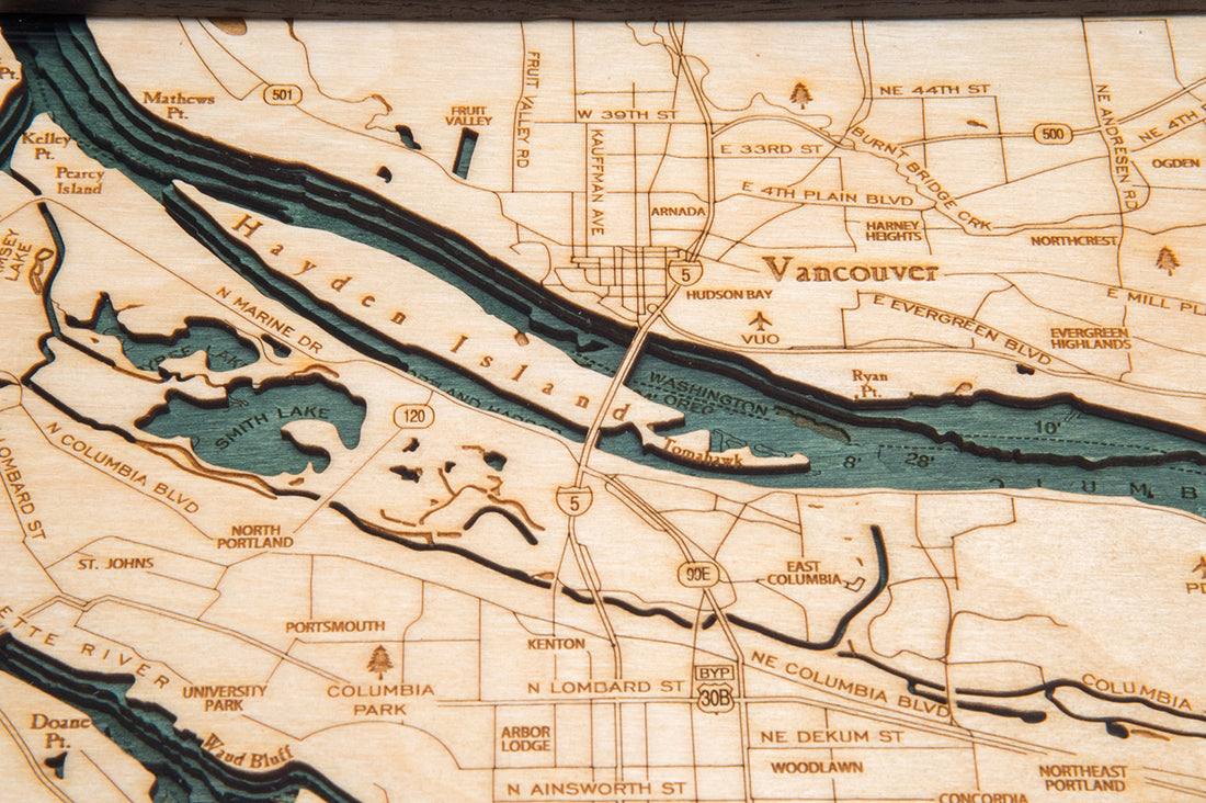 Portland, Oregon 3D layered wood map in laser-cut Baltic birch, shown framed against a light wall