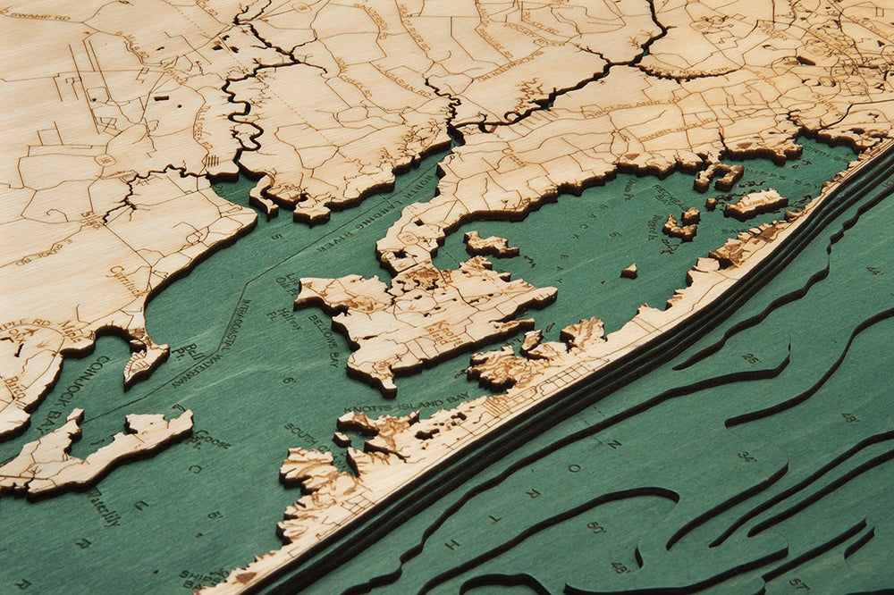 Virginia Beach to Kitty Hawk 3D layered wood map in laser-cut Baltic birch, shown framed against a light wall