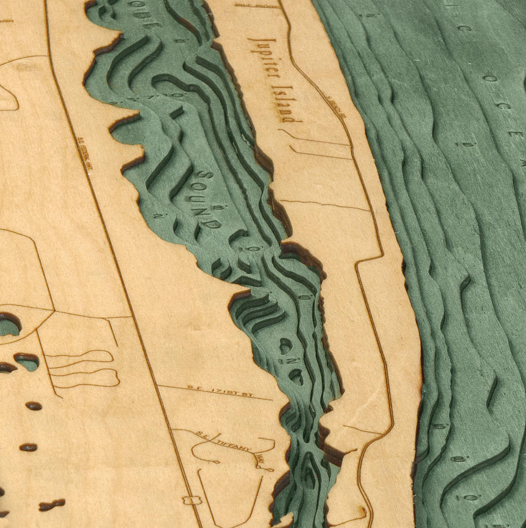 Jupiter Island, Florida 3D layered wood map in laser-cut Baltic birch, shown framed against a light wall
