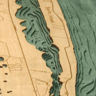 Jupiter Island, Florida 3D layered wood map in laser-cut Baltic birch, shown framed against a light wall