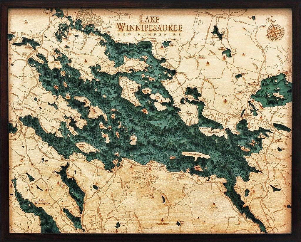 Lake Winnipesaukee, New Hampshire 3D layered wood map in laser-cut Baltic birch, shown framed against a light wall