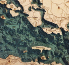 Lake Winnipesaukee, New Hampshire 3D layered wood map in laser-cut Baltic birch, shown framed against a light wall