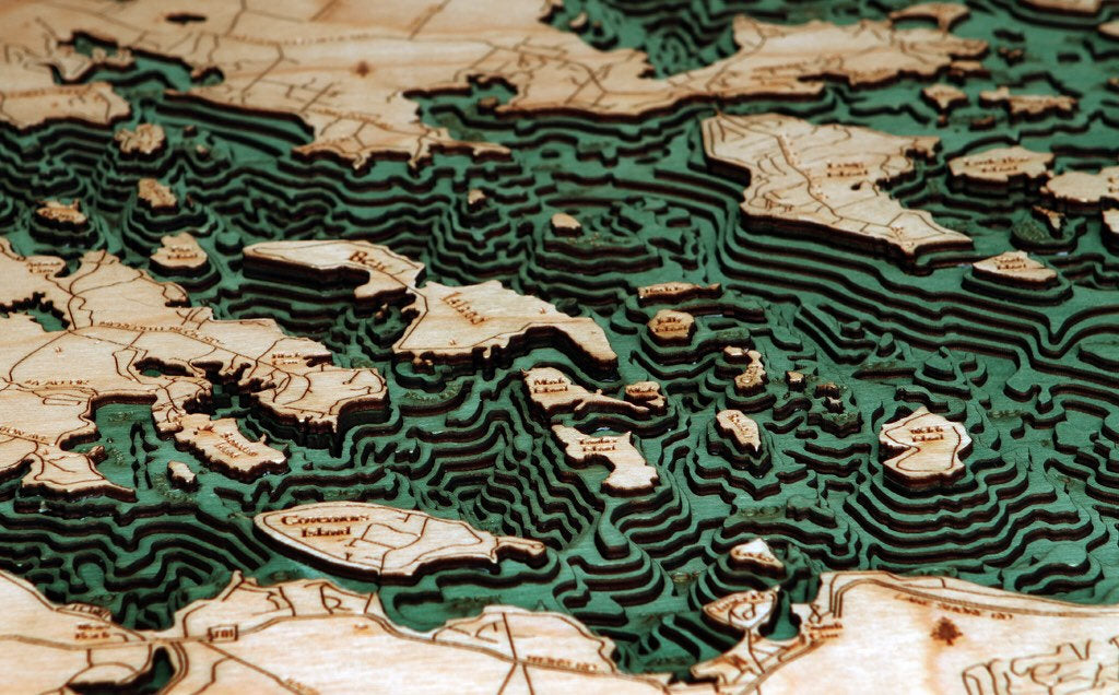 Lake Winnipesaukee, New Hampshire 3D layered wood map in laser-cut Baltic birch, shown framed against a light wall