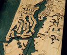 Naples, Florida 3D layered wood map in laser-cut Baltic birch, shown framed against a light wall