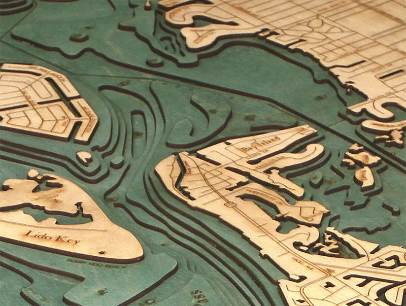 Siesta Key, Florida 3D layered wood map in laser-cut Baltic birch, shown framed against a light wall