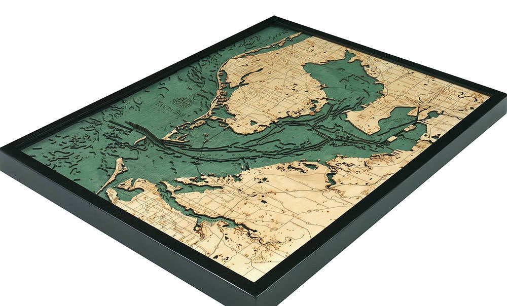 Tampa Bay, Florida 3D layered wood map in laser-cut Baltic birch, shown framed against a light wall