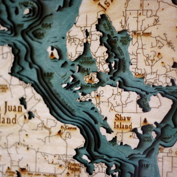 San Juan Islands, Washington 3D layered wood map in laser-cut Baltic birch, shown framed against a light wall