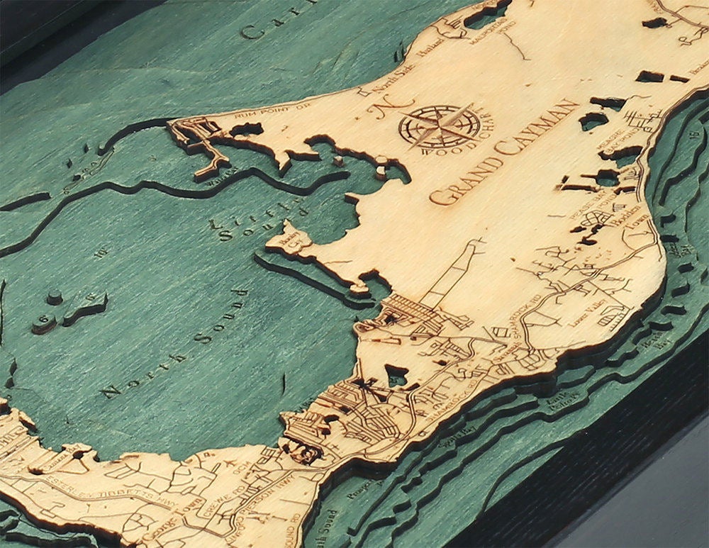 Grand Cayman, Caribbean 3D layered wood map in laser-cut Baltic birch, shown framed against a light wall