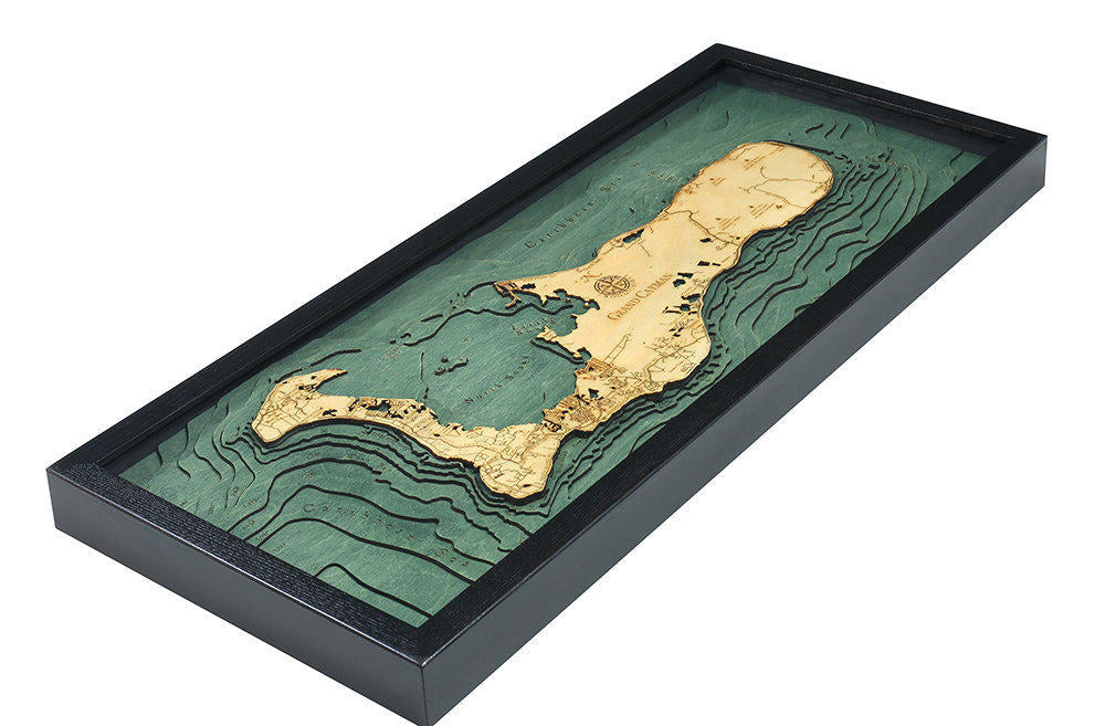 Grand Cayman, Caribbean 3D layered wood map in laser-cut Baltic birch, shown framed against a light wall